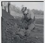 Public health official checking dirt